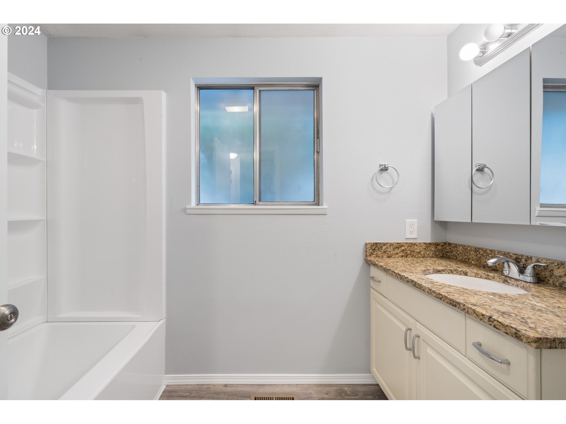 12841 Southeast Foster Road Portland, OR 97236 - Photo 39 of 48 a bathroom with a granite countertop sink and a mirror