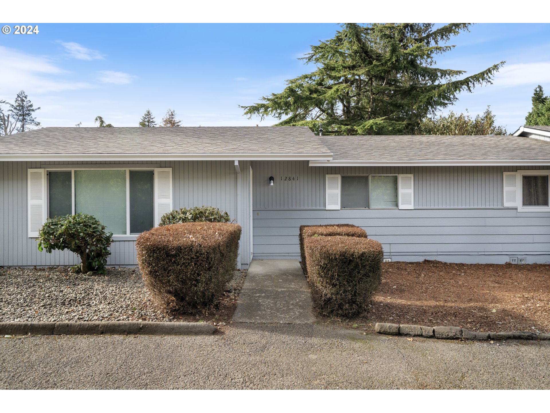 12841 Southeast Foster Road Portland, OR 97236 - Photo 5 of 48 a front view of a house with balcony