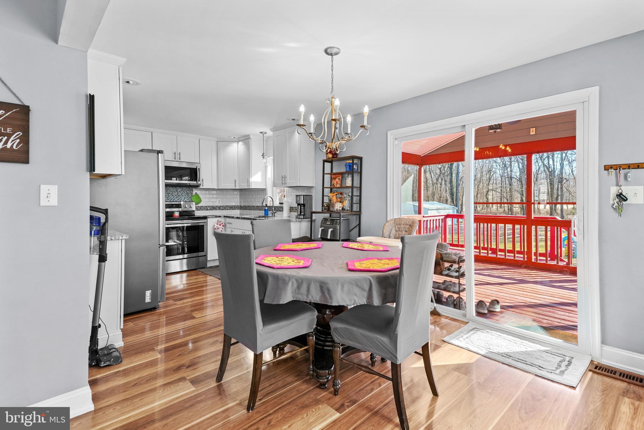 1435 Shadyrest Road Shady Side, MD 20764 - Photo 12 of 36 a view of a dining room with furniture a chandelier and wooden floor