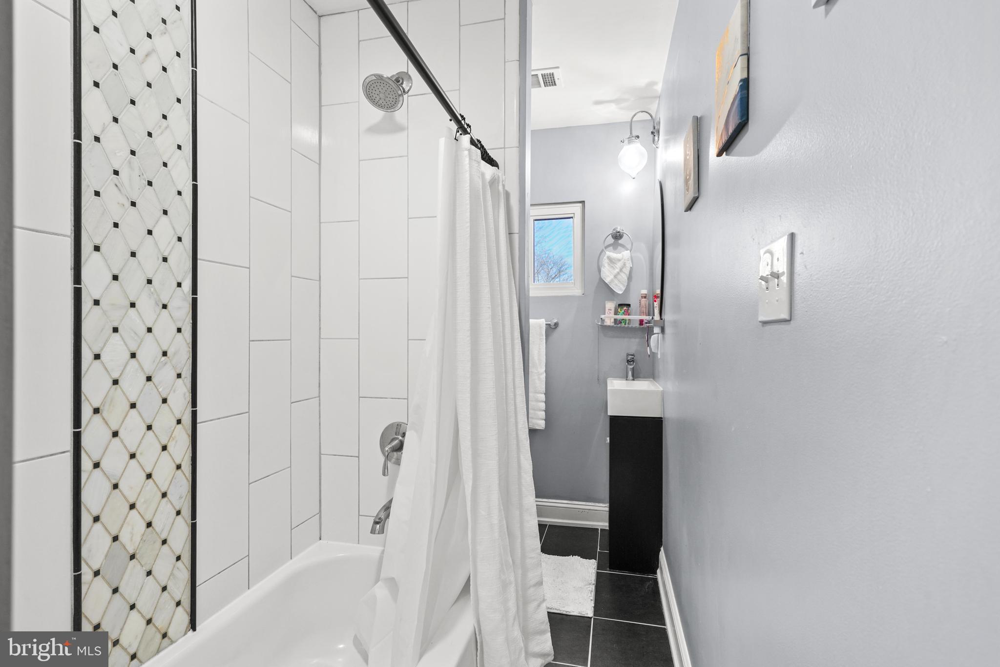 1435 Shadyrest Road Shady Side, MD 20764 - Photo 26 of 36 a bathroom with a bathtub and a shower