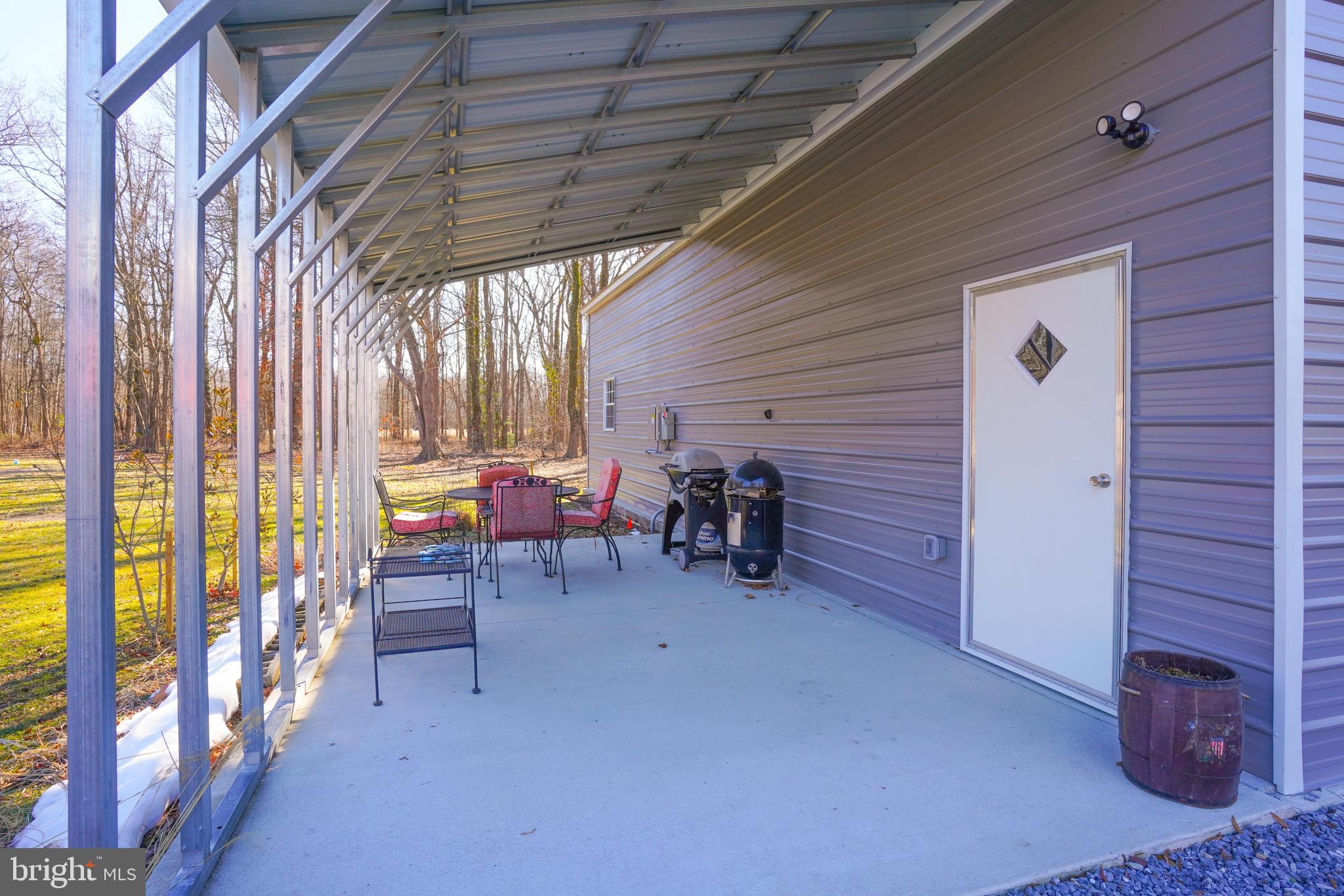 1435 Shadyrest Road Shady Side, MD 20764 - Photo 3 of 36 a view of a porch with furniture and a gate