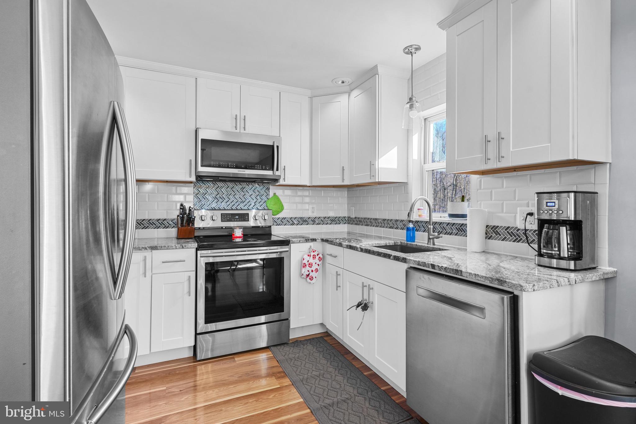 1435 Shadyrest Road Shady Side, MD 20764 - Photo 9 of 36 a kitchen with stainless steel appliances granite countertop a stove a sink and a refrigerator