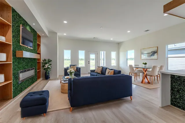 a living room with furniture wooden floor and a fireplace