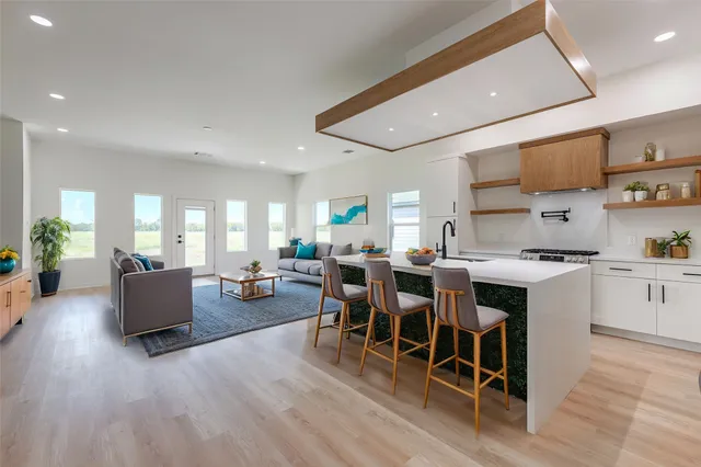 a large kitchen with a table and chairs in it