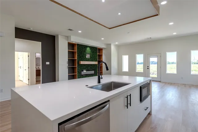 a kitchen with sink and refrigerator