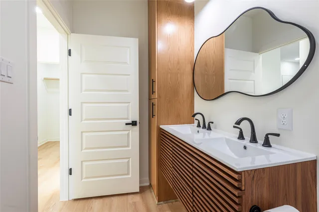 a bathroom with a sink a mirror and a shower