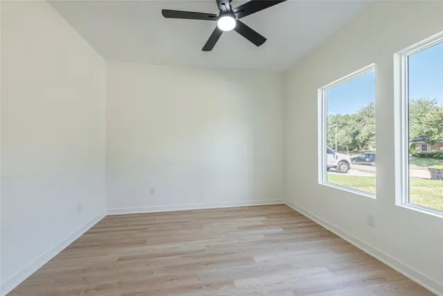 wooden floor in an empty room with a window