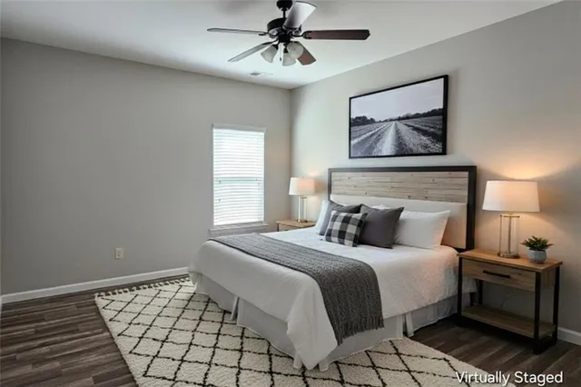 a bedroom with a bed and a painting on the wall