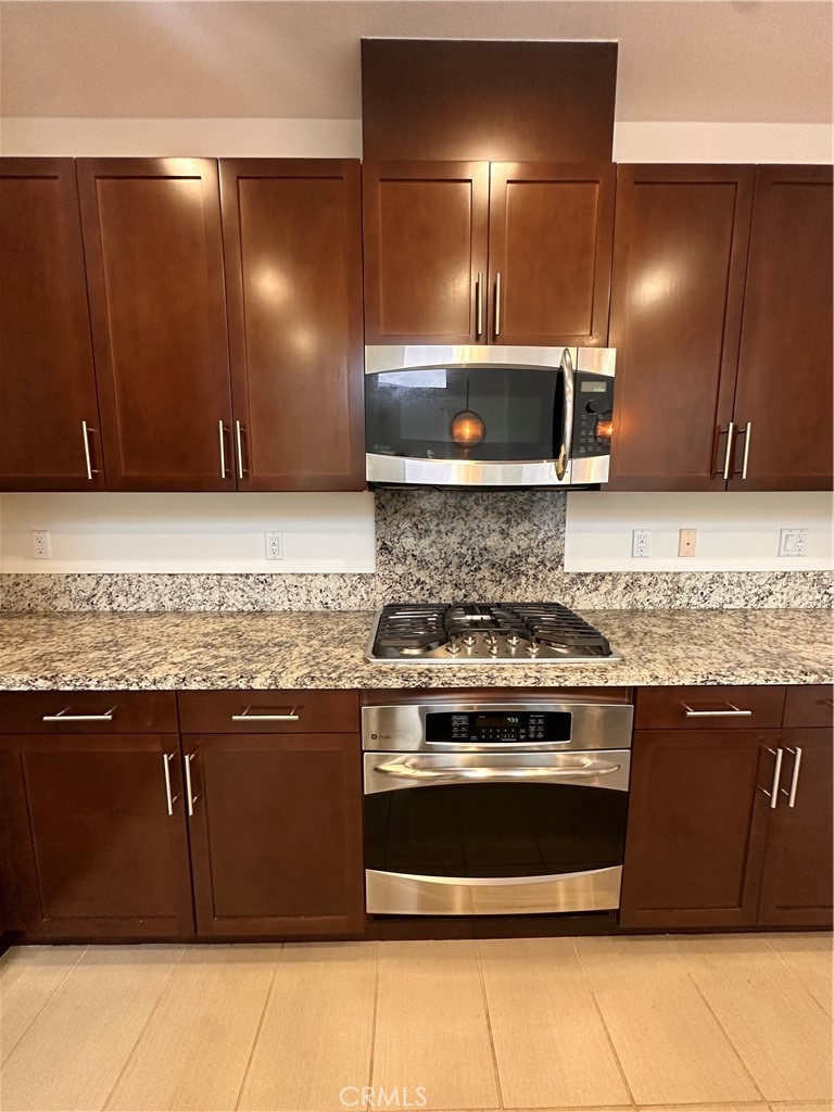 27 Soho Irvine, CA 92612 - Photo 11 of 69 a kitchen with a stove and a sink