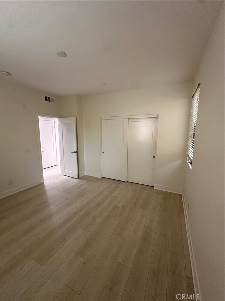 27 Soho Irvine, CA 92612 - Photo 28 of 69 an empty room with wooden floor and windows