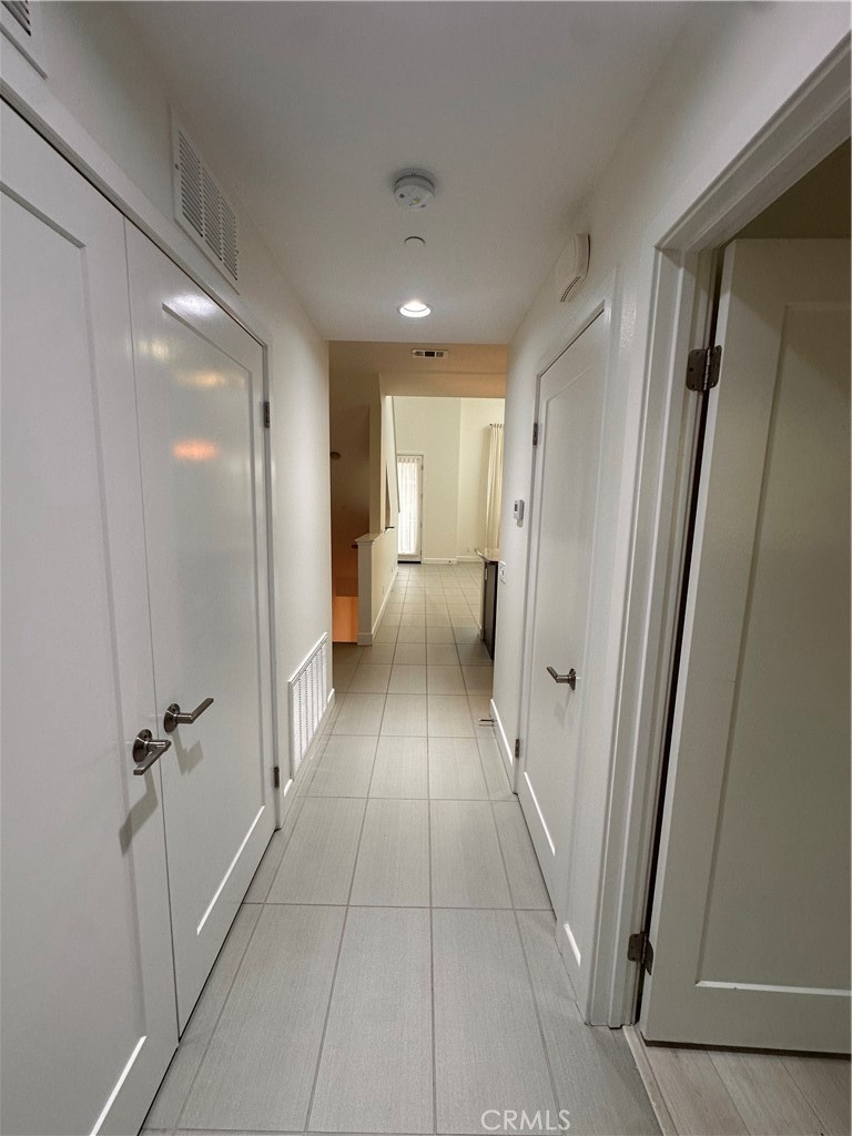 27 Soho Irvine, CA 92612 - Photo 30 of 69 a view of a hallway with a furniture and a refrigerator