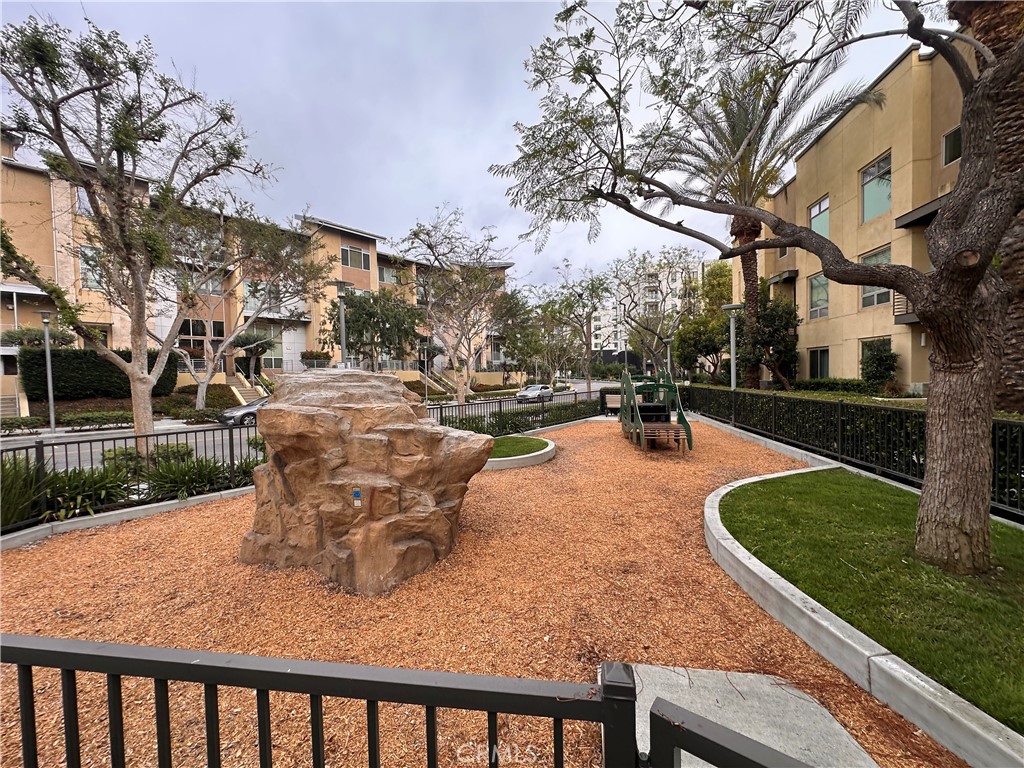 27 Soho Irvine, CA 92612 - Photo 48 of 69 a view of a patio with table and chairs with wooden fence and plants