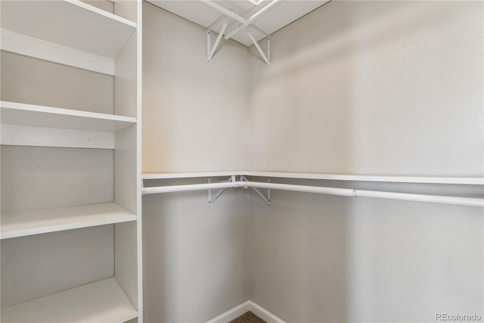 5031 South Rome Street Aurora, CO 80015 - Photo 21 of 39 a view of an empty walk in closet
