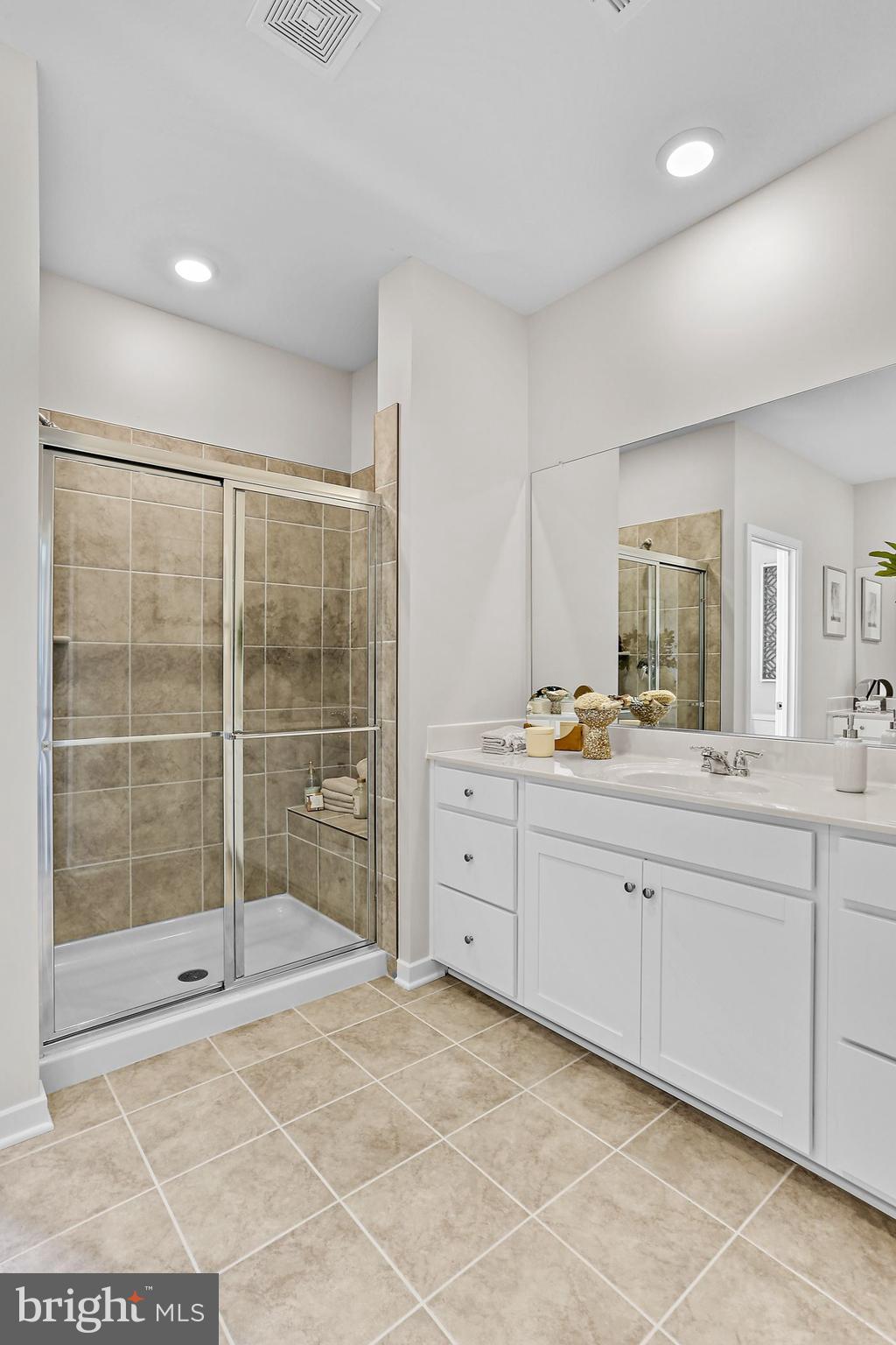 288 Short Br Drive, Unit ASHTON 244 Ranson, WV 25438 - Photo 26 of 41 a spacious bathroom with a shower sink and mirror