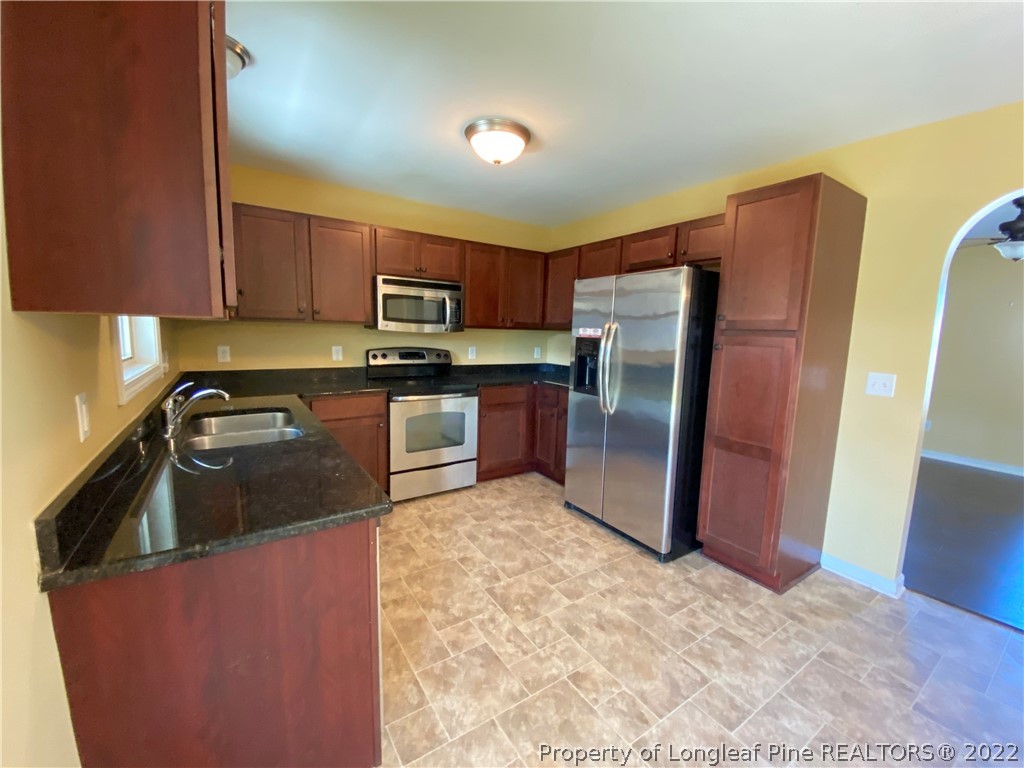76 Loyalist Road Cameron, NC 28326 - Photo 6 of 34 a kitchen with stainless steel appliances granite countertop a refrigerator a stove a sink a microwave a sink and dishwasher