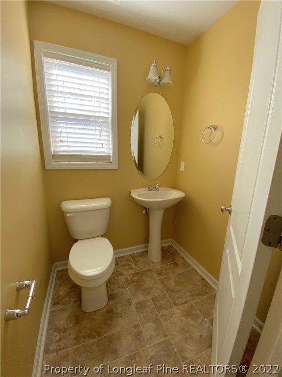 76 Loyalist Road Cameron, NC 28326 - Photo 8 of 34 a bathroom with a toilet sink and a mirror