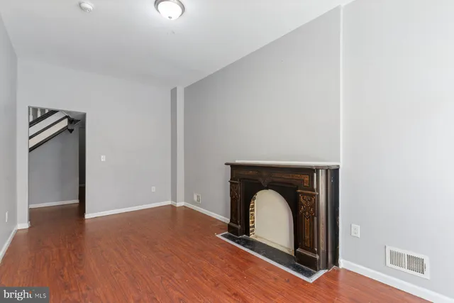 a room with a fireplace and wooden floor