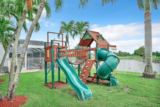 a view of staircase with lots of frames on wall and a window