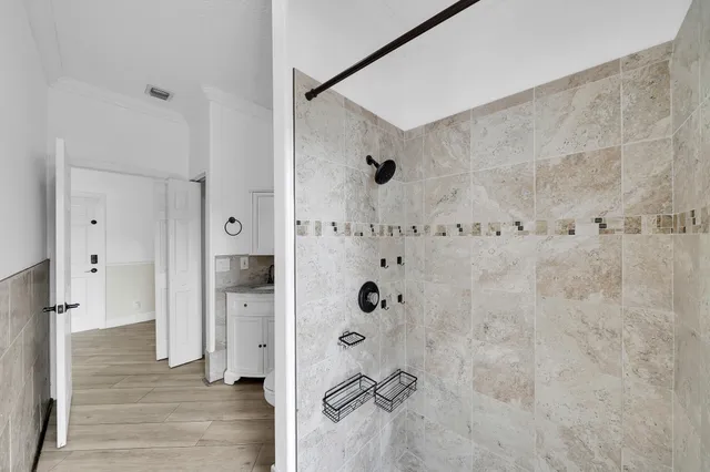 a view of a hallway with wooden floor