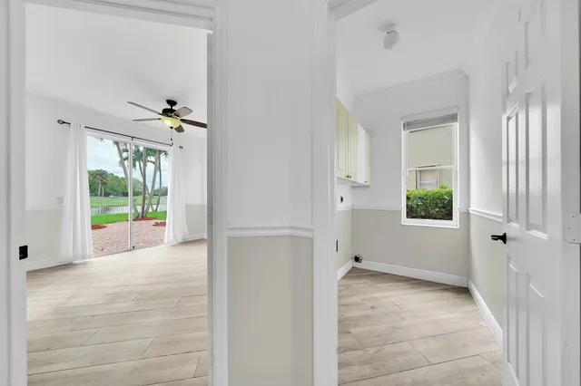 a view of an empty room and window with wooden floor