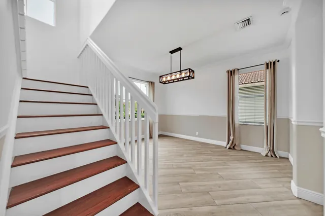 a large white kitchen with a sink and cabinets
