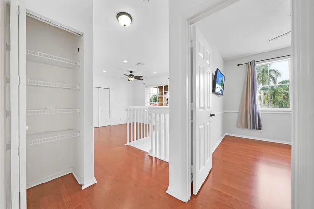 an aerial view of residential houses with outdoor space and trees