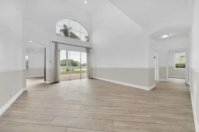 a view of an empty room and wooden floor