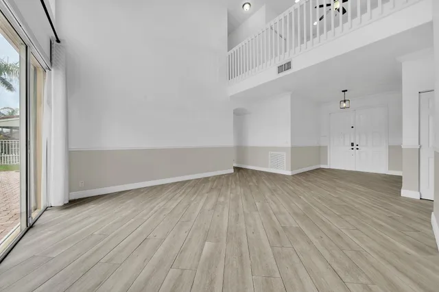 a large kitchen with stainless steel appliances granite countertop a lot of counter space and wooden floors