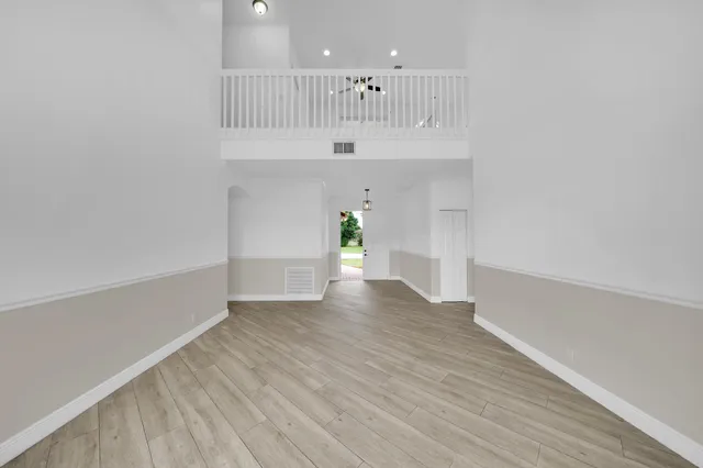 a large kitchen with stainless steel appliances kitchen island granite countertop a stove a sink dishwasher and a oven with wooden cabinets