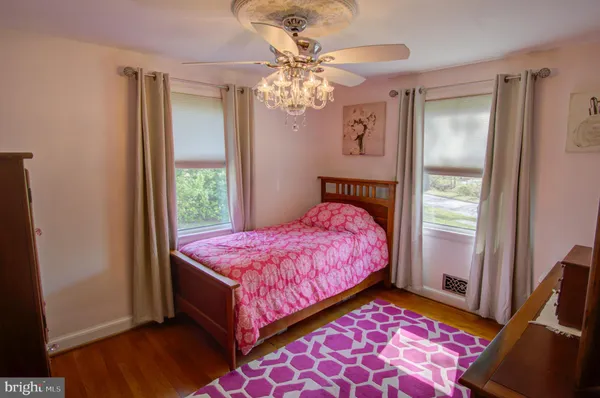 a bedroom with a bed mirror and a window