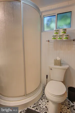 a white toilet sitting next to a bathroom sink
