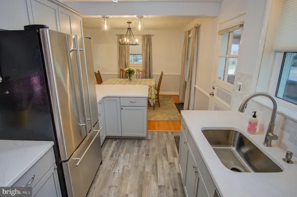 a kitchen with sink a refrigerator and washer