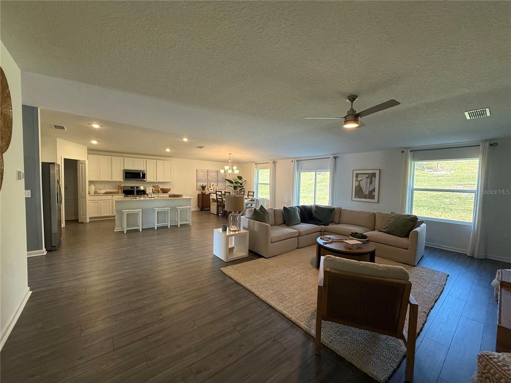 4220 Southwest 82nd Lane Ocala, FL 34476 - Photo 5 of 18 a living room with furniture wooden floor and a kitchen