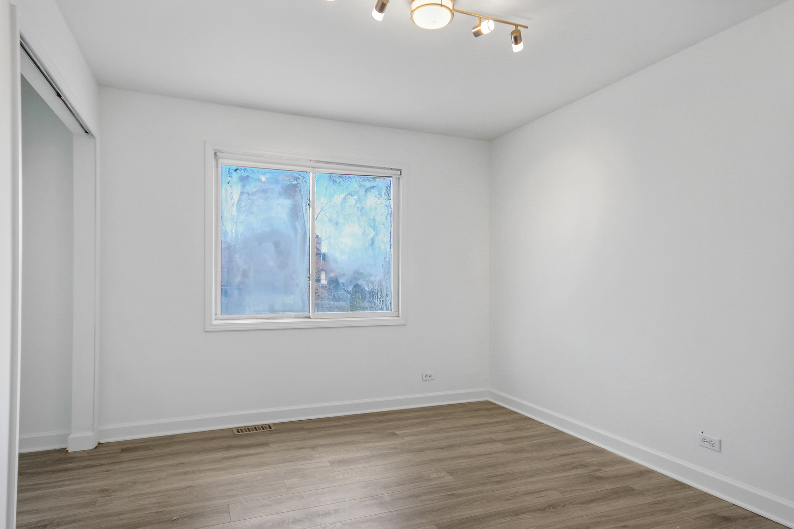 2938 East Shagbark Trail Crete, IL 60417 - Photo 17 of 22 a view of an empty room with wooden floor and a window