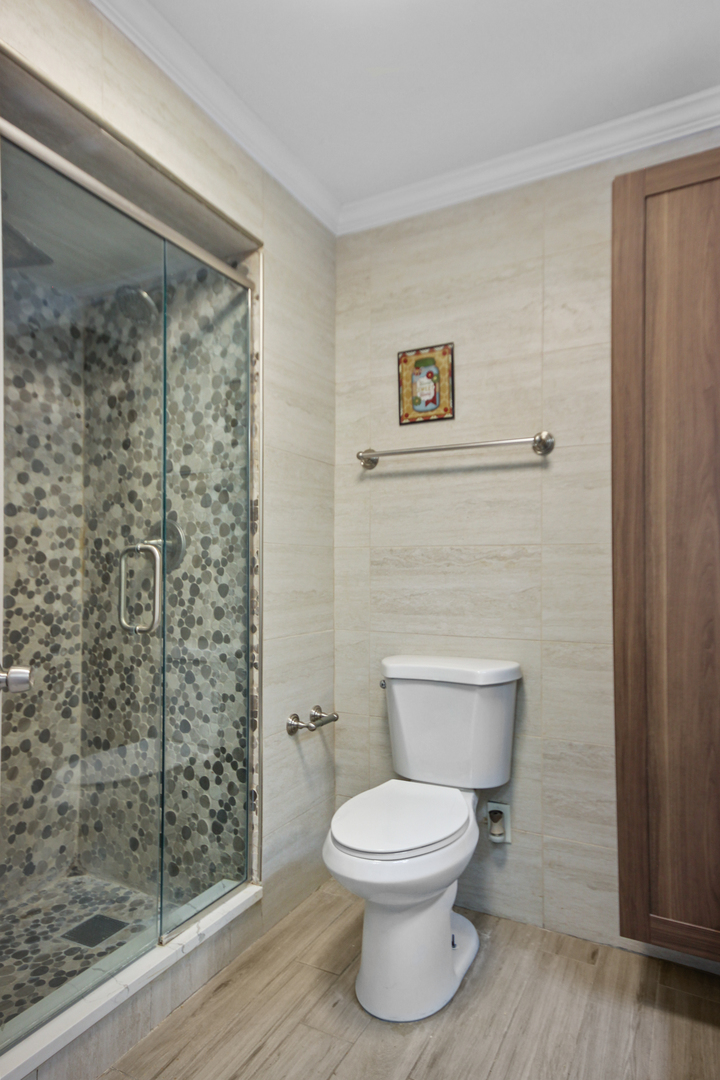 2938 East Shagbark Trail Crete, IL 60417 - Photo 19 of 22 a bathroom with a toilet and a shower