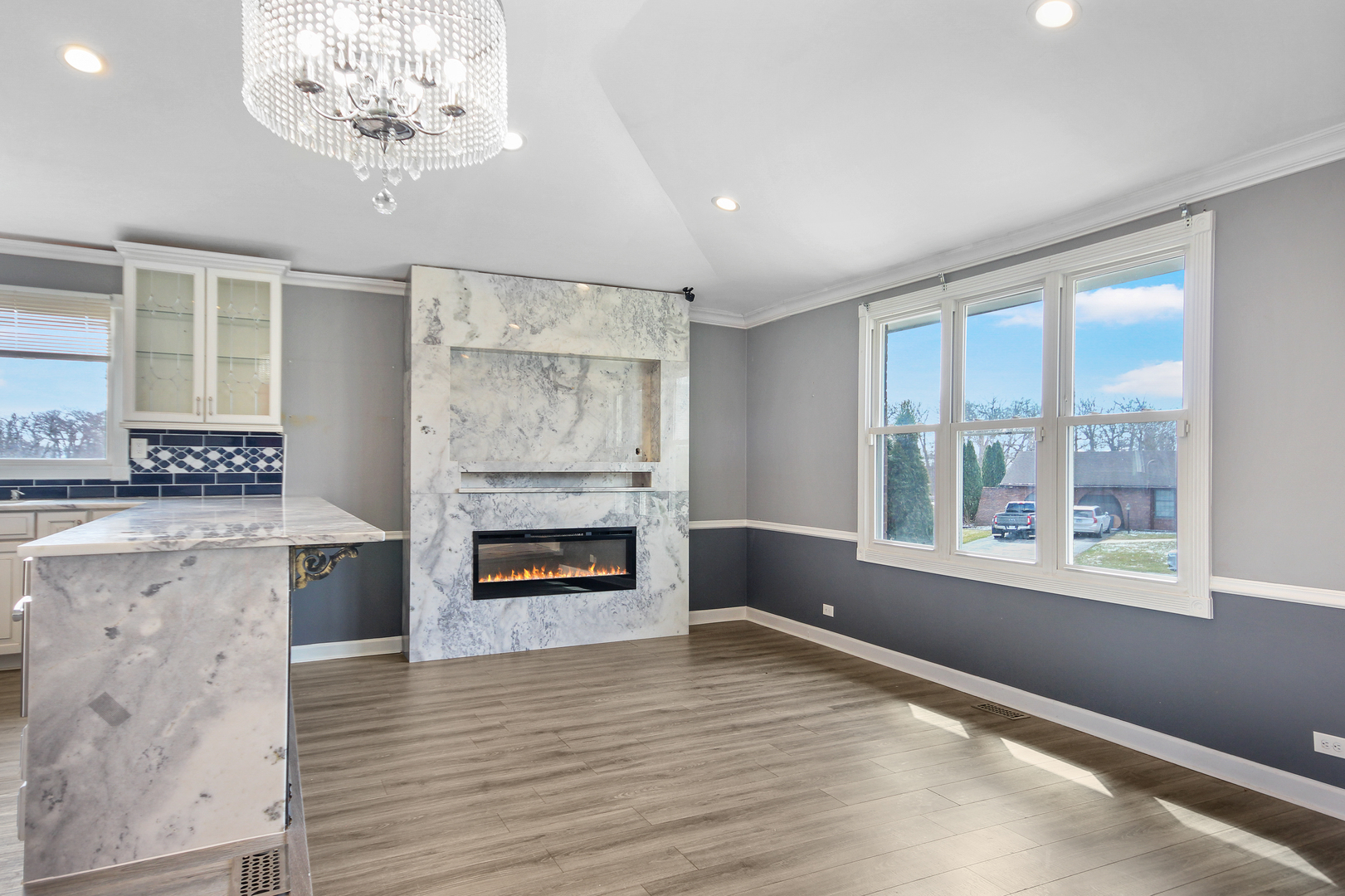 2938 East Shagbark Trail Crete, IL 60417 - Photo 7 of 22 an empty room with windows fireplace and wooden floor