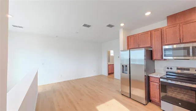 a kitchen with stainless steel appliances a refrigerator and a stove