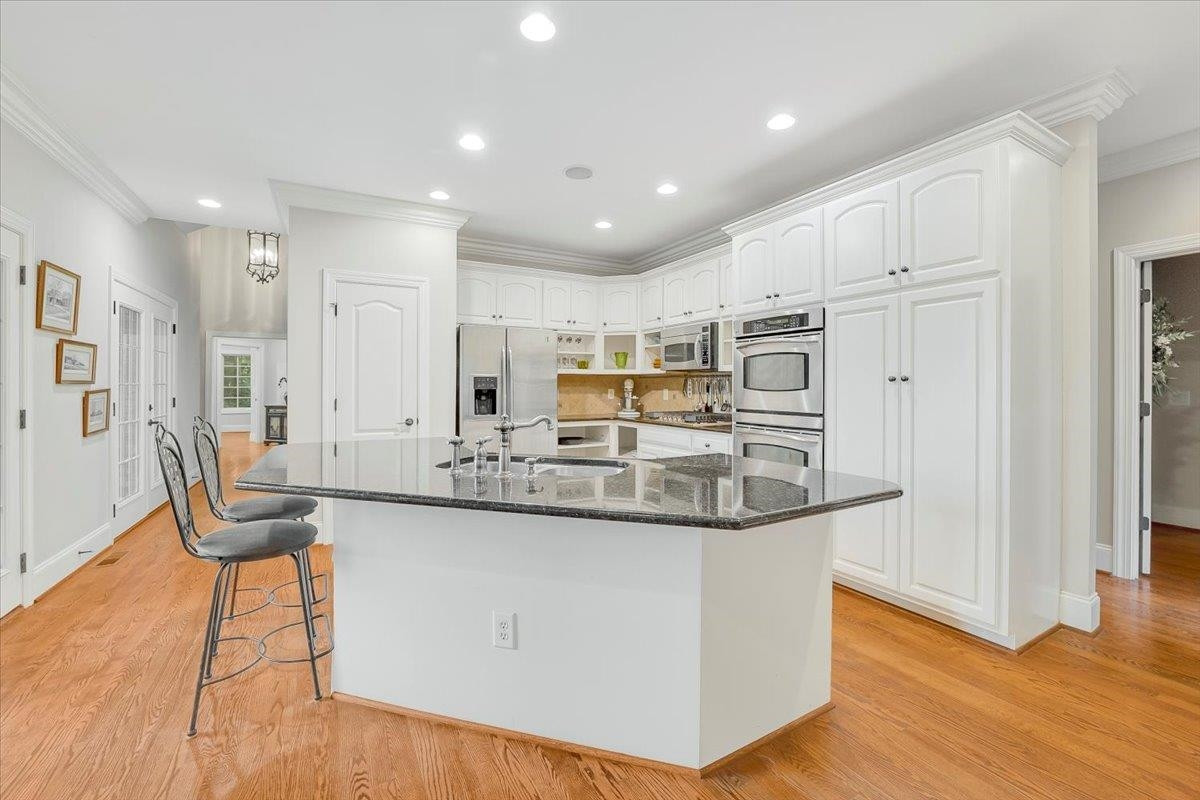 5401 Nicks Road Mebane, NC 27302 - Photo 12 of 53 a kitchen with stainless steel appliances granite countertop a sink and a refrigerator