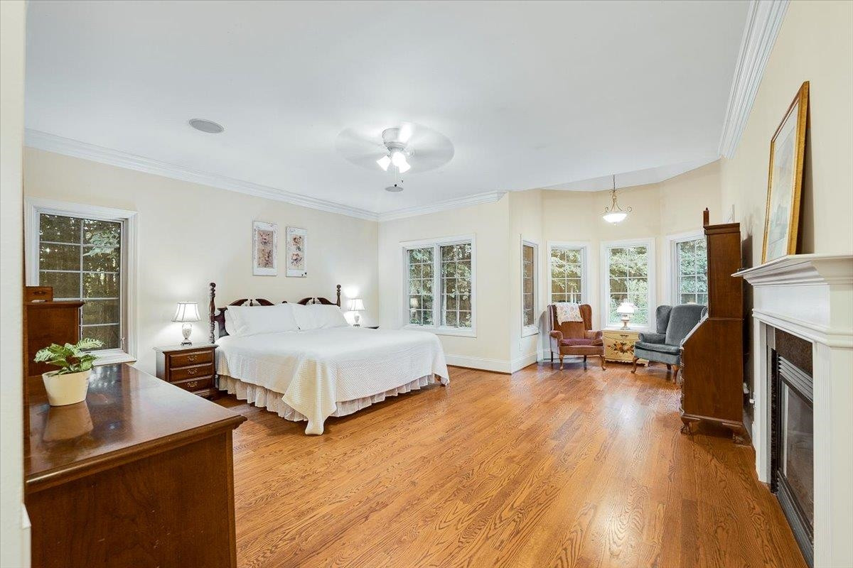5401 Nicks Road Mebane, NC 27302 - Photo 13 of 53 a spacious bedroom with a bed and wooden floor