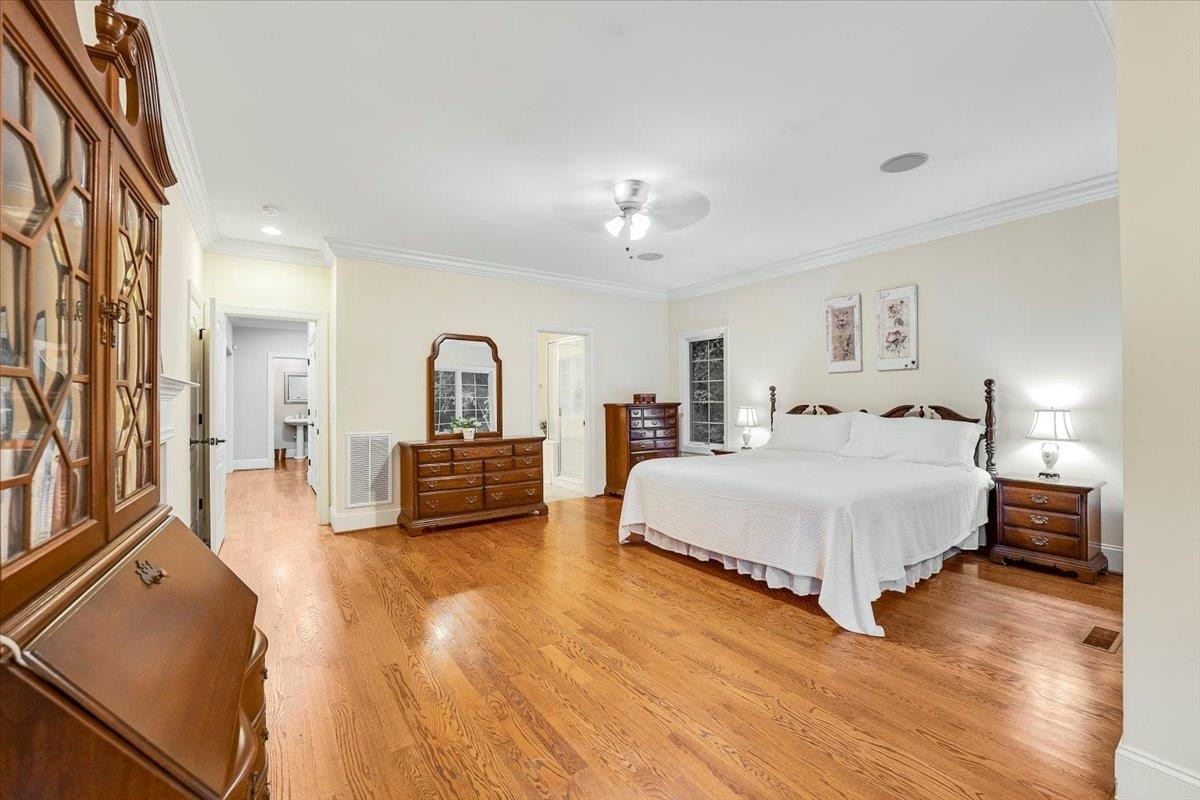 5401 Nicks Road Mebane, NC 27302 - Photo 14 of 53 a spacious bedroom with a bed a couch and dresser