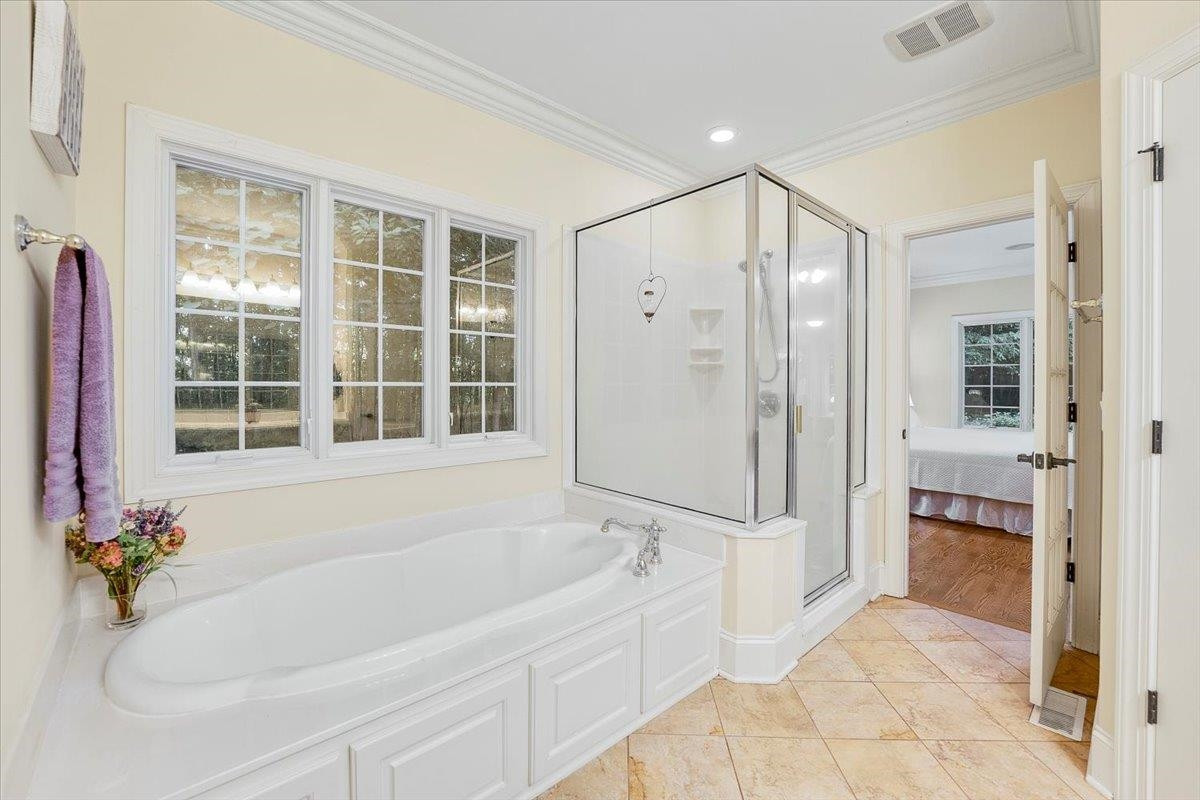 5401 Nicks Road Mebane, NC 27302 - Photo 17 of 53 a bathroom with a bathtub and a shower