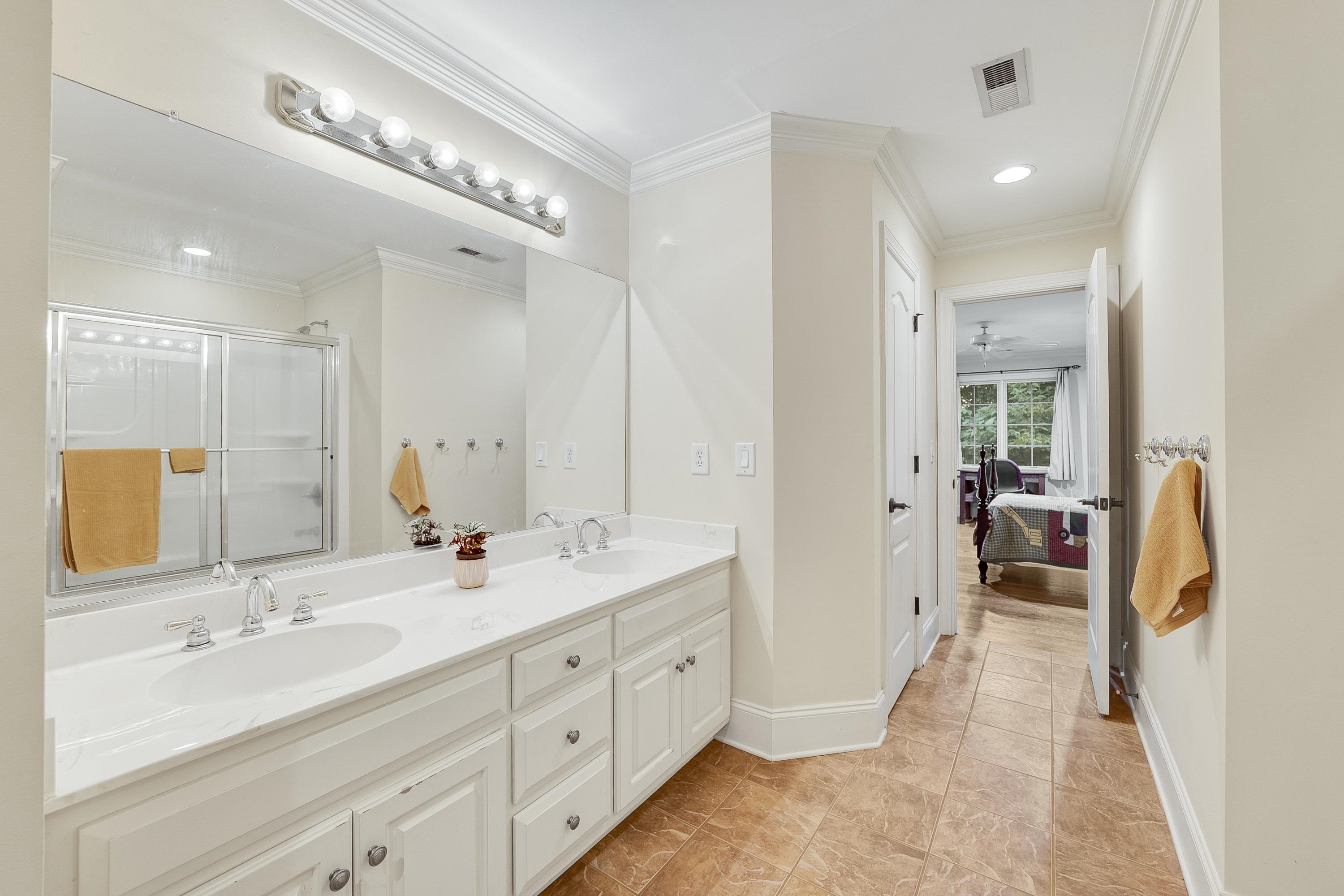 5401 Nicks Road Mebane, NC 27302 - Photo 26 of 53 a en suite bathroom with double sink and a large mirror