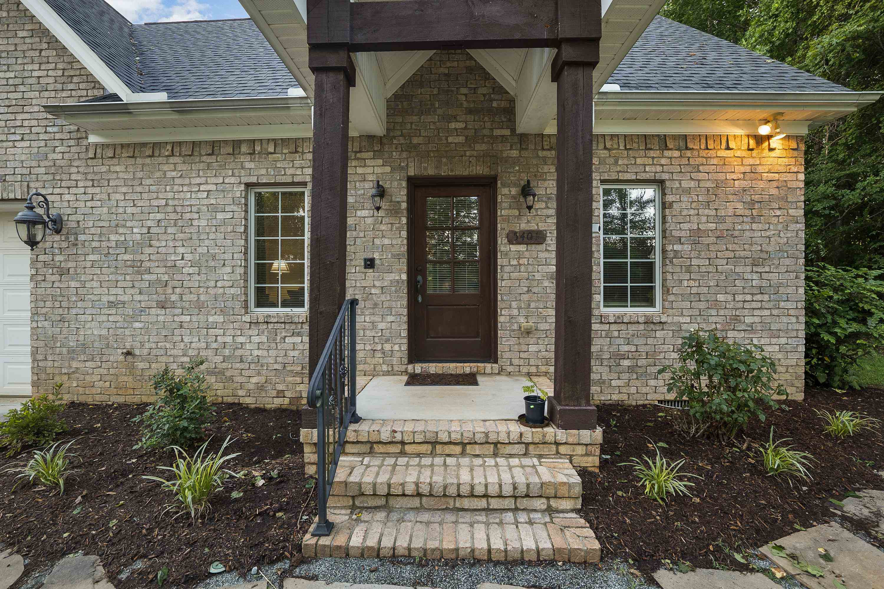 5401 Nicks Road Mebane, NC 27302 - Photo 30 of 53 a front view of a house with a garden
