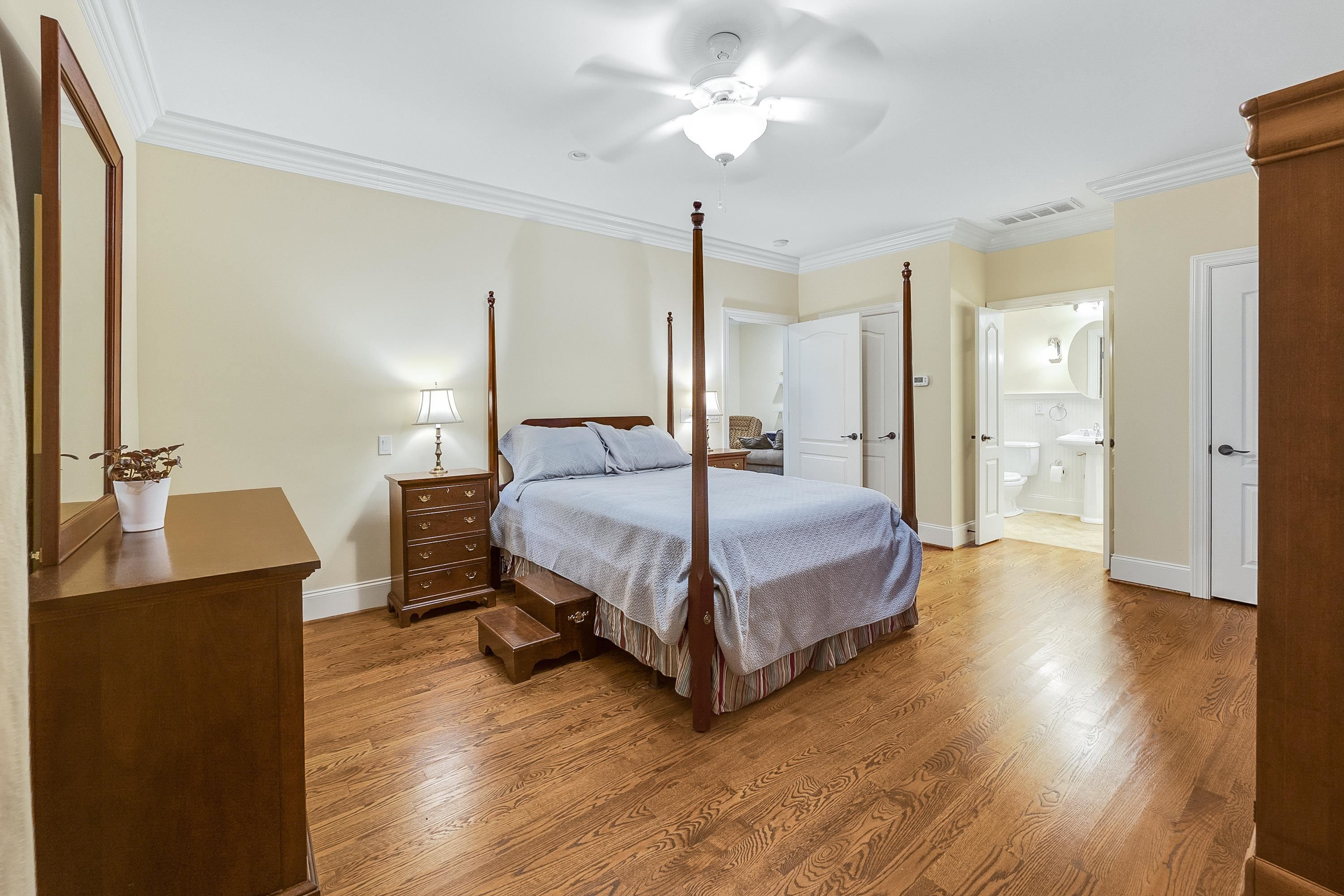 5401 Nicks Road Mebane, NC 27302 - Photo 35 of 53 a spacious bedroom with a bed and wooden floor