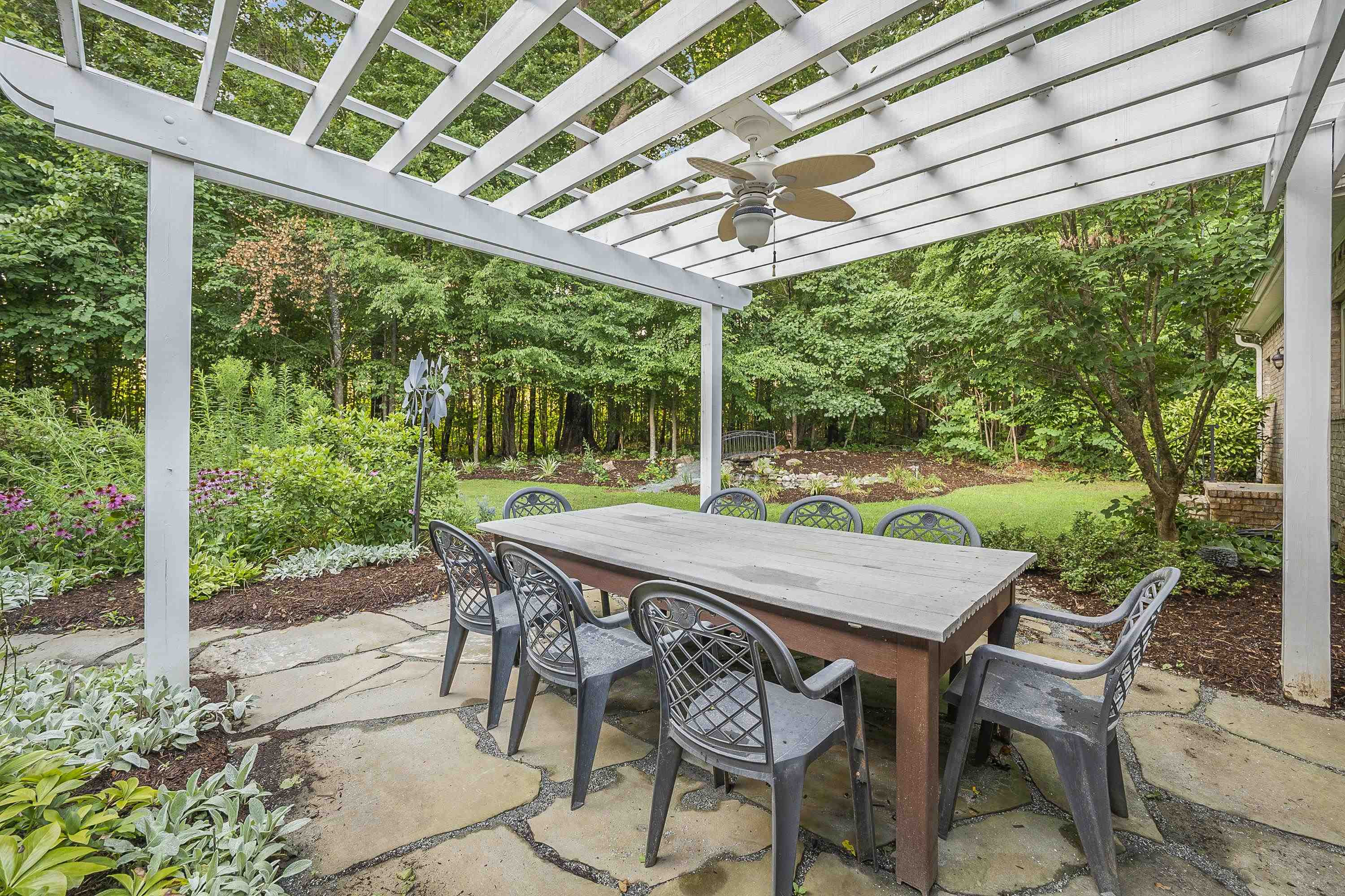 5401 Nicks Road Mebane, NC 27302 - Photo 38 of 53 a patio with table and chairs and couches with wooden roof and stairs