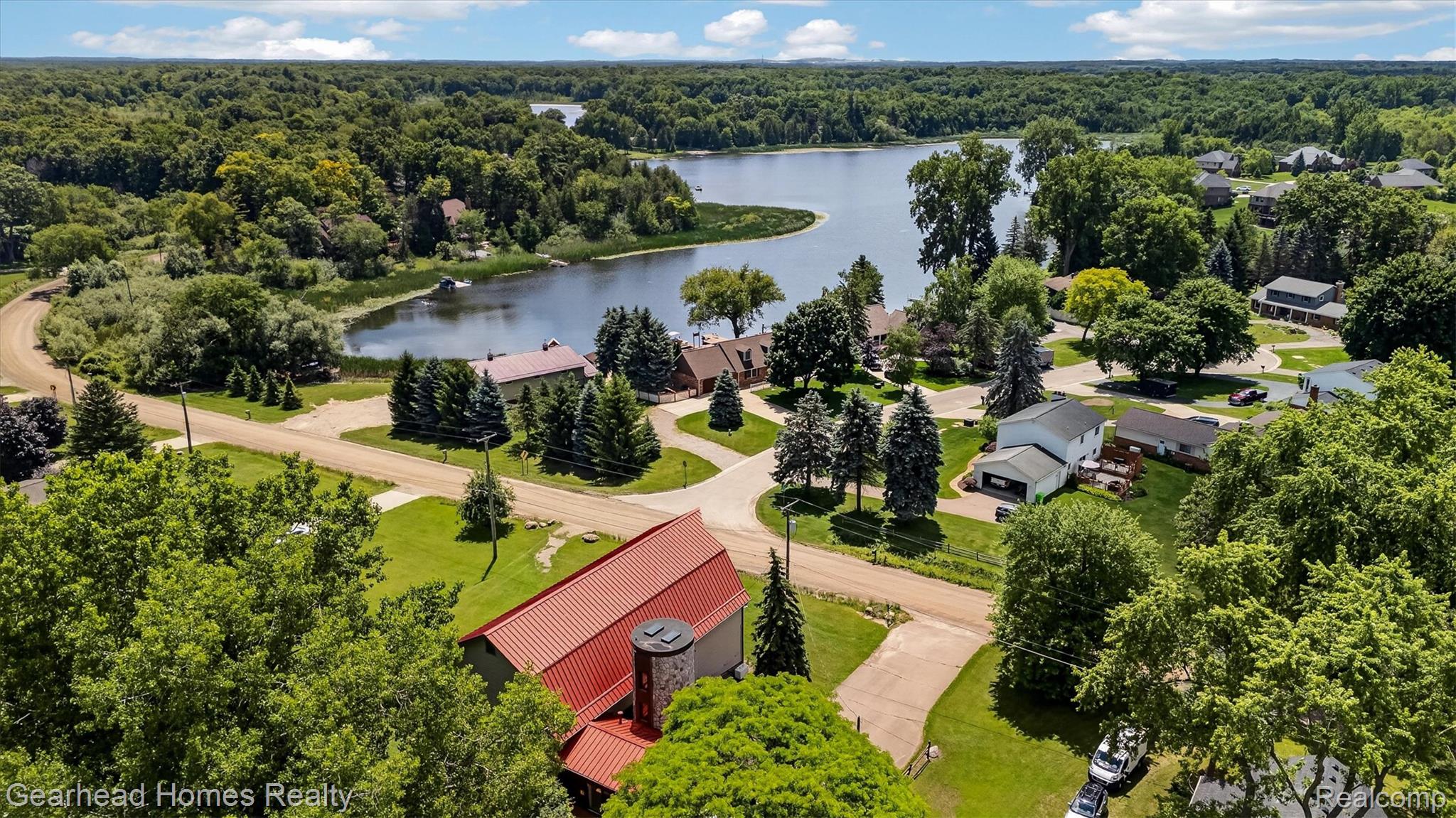 3486 West Drahner Road Oxford, MI 48371 - Photo 46 of 51 Aerial perspective showcasing a lakefront community with mature trees and established residences