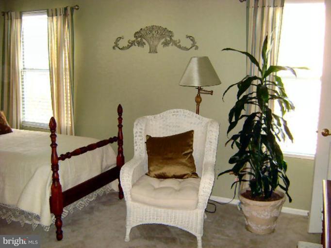 604 Churchill Road, Unit O Bel Air, MD 21014 - Photo 17 of 30 a bed sitting in a bedroom next to a window