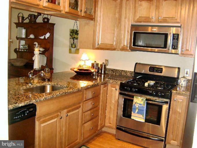 604 Churchill Road, Unit O Bel Air, MD 21014 - Photo 9 of 30 a kitchen with granite countertop a stove and a microwave