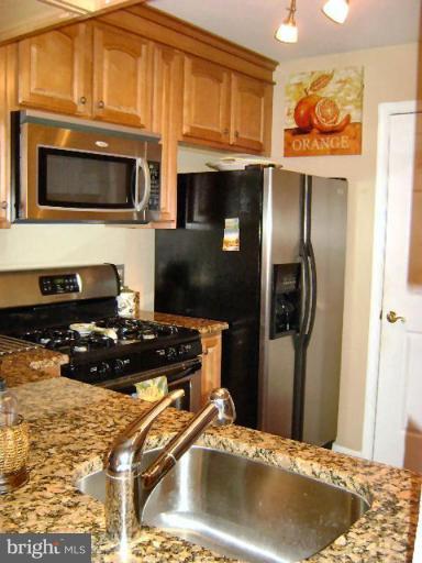 604 Churchill Road, Unit O Bel Air, MD 21014 - Photo 10 of 30 a kitchen with stainless steel appliances granite countertop a stove and a microwave
