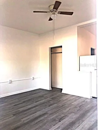 a view of an empty room with wooden floor